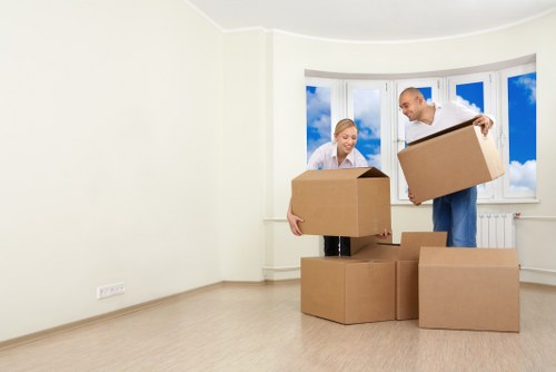 Removal team carrying household items through a Downe property
